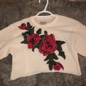 Long sleeve crop top with 3D floral decor.